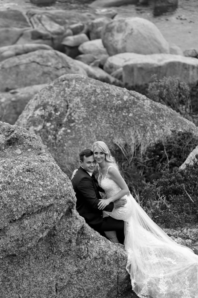 Black and white wedding photograph of the married couple on the beach in Camps Bay