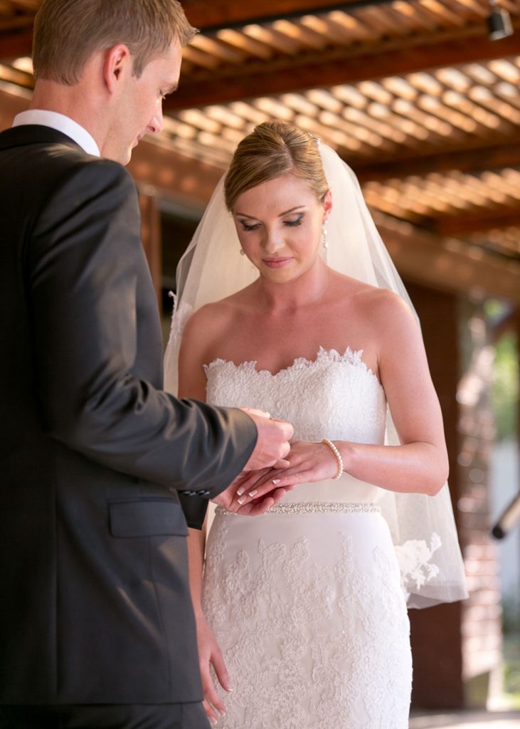 groom slipping on the wedding ring at The Palazzo Hotel Montecasino in Johannesburg