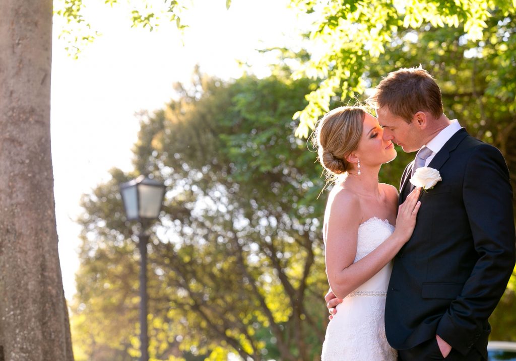 bride and groom kissing in the sun at The Palazzo Hotel Montecasino in Johannesburg