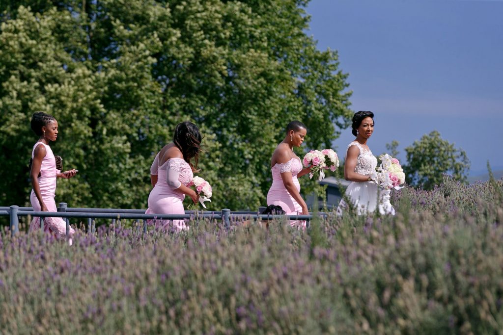 Bridesmaids in pretty pink dresses walking past Brahman Hills Spa