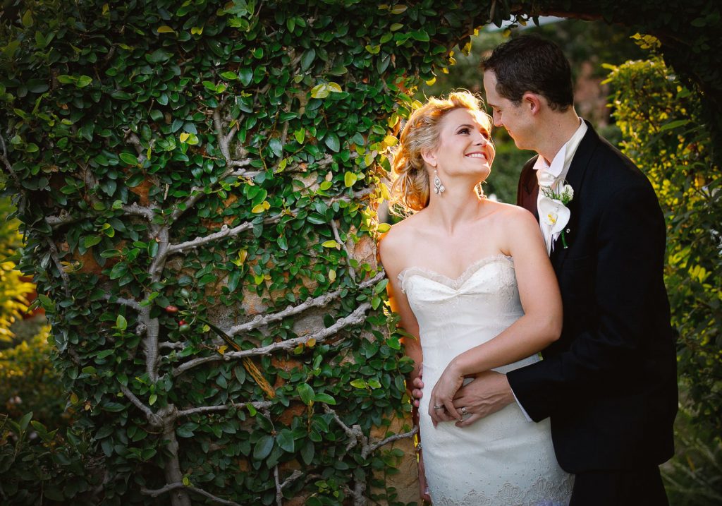 wedding couple standing under the green arch at Shepstone Gardens Wedding Venue