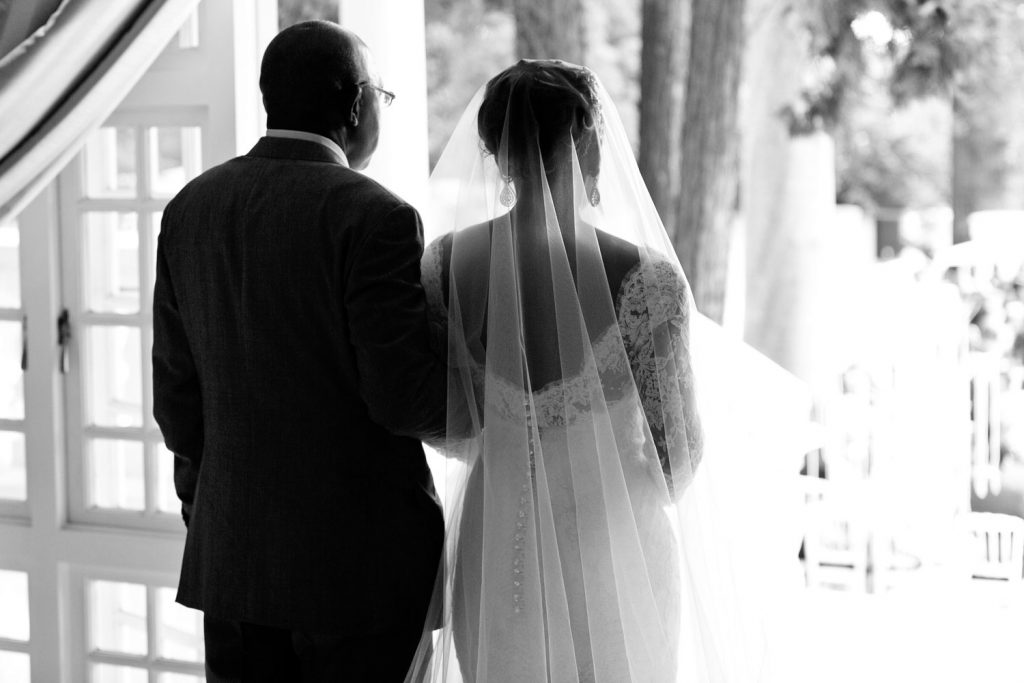 black and white image of the father and the bride walking down the aisle at a garden wedding in Johannesburg