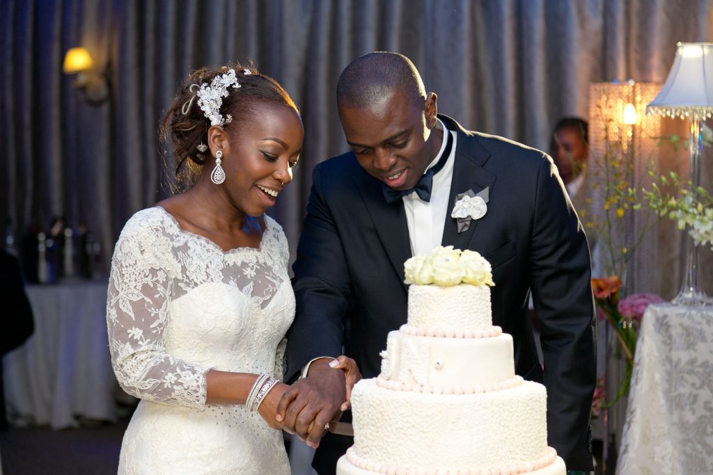 white wedding cake being cut at Summer Place