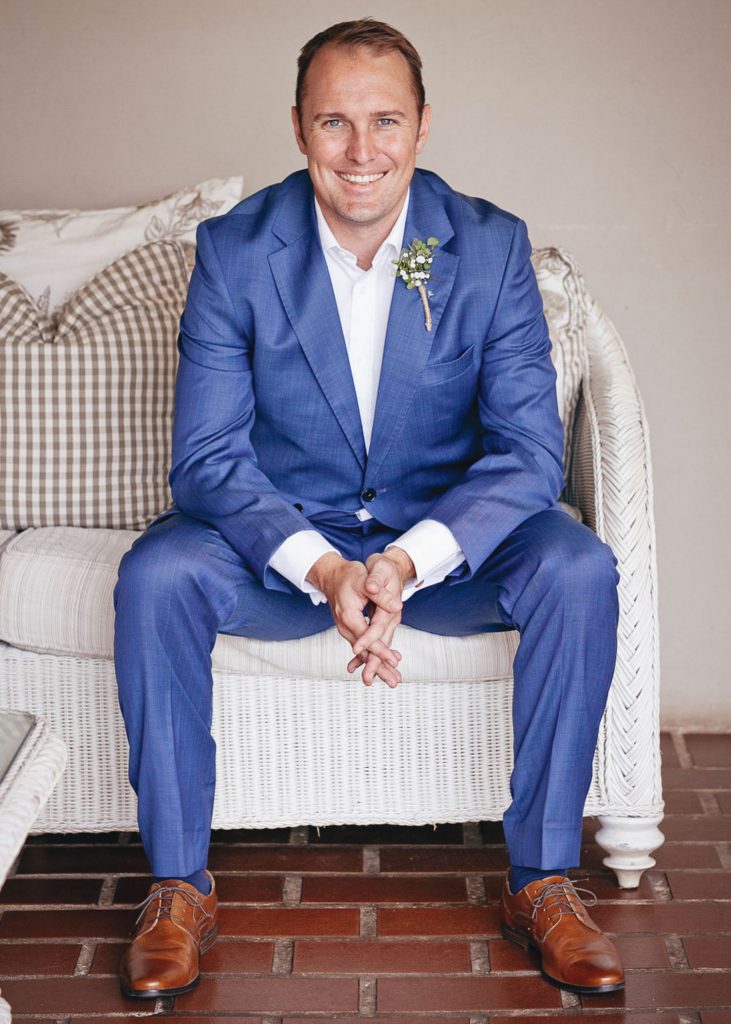 Groom wearing a blue wedding suit with brown shoes at Greenleaves Wedding Venue
