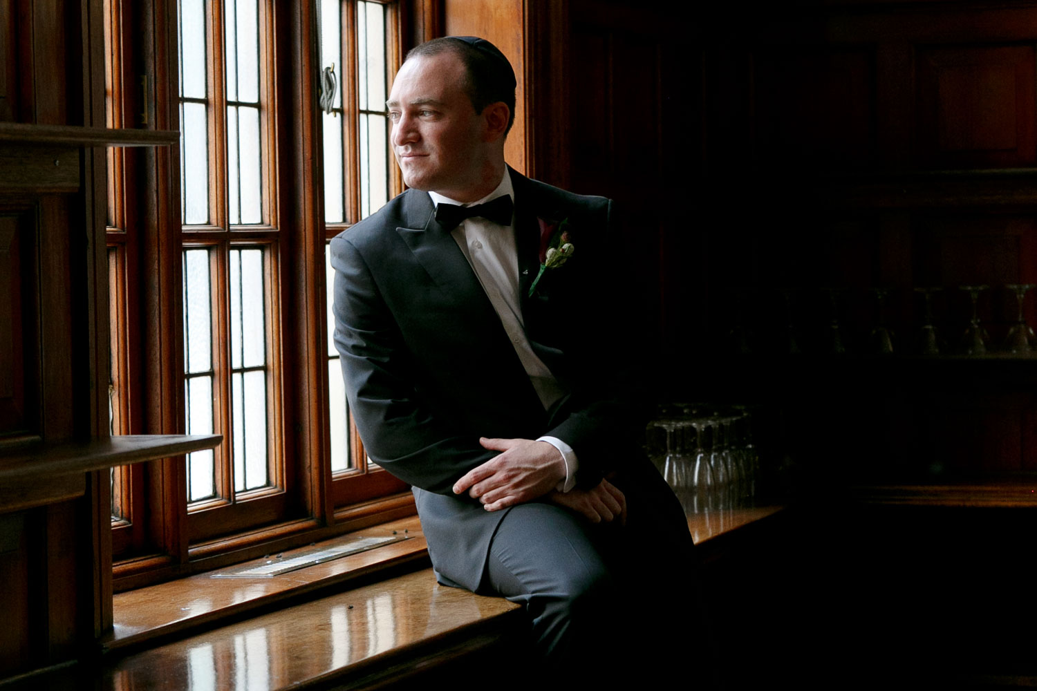 Jewish Groom sitting by a window at The Rand Club in Johannesburg