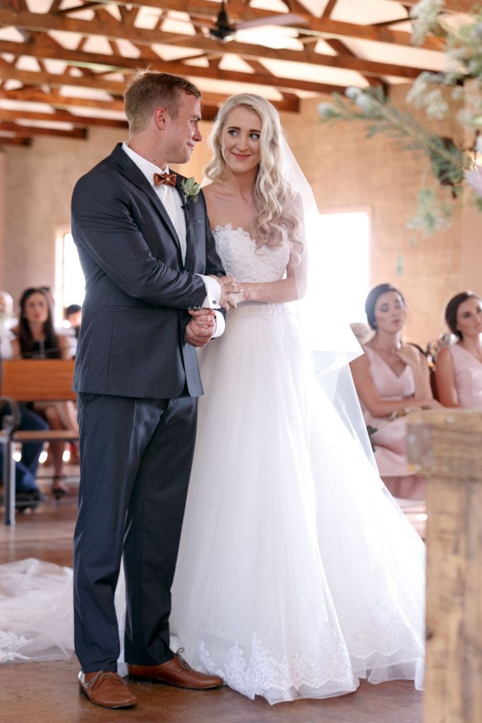 bride smiling at the groom at Lezar Opstal Wedding Venue