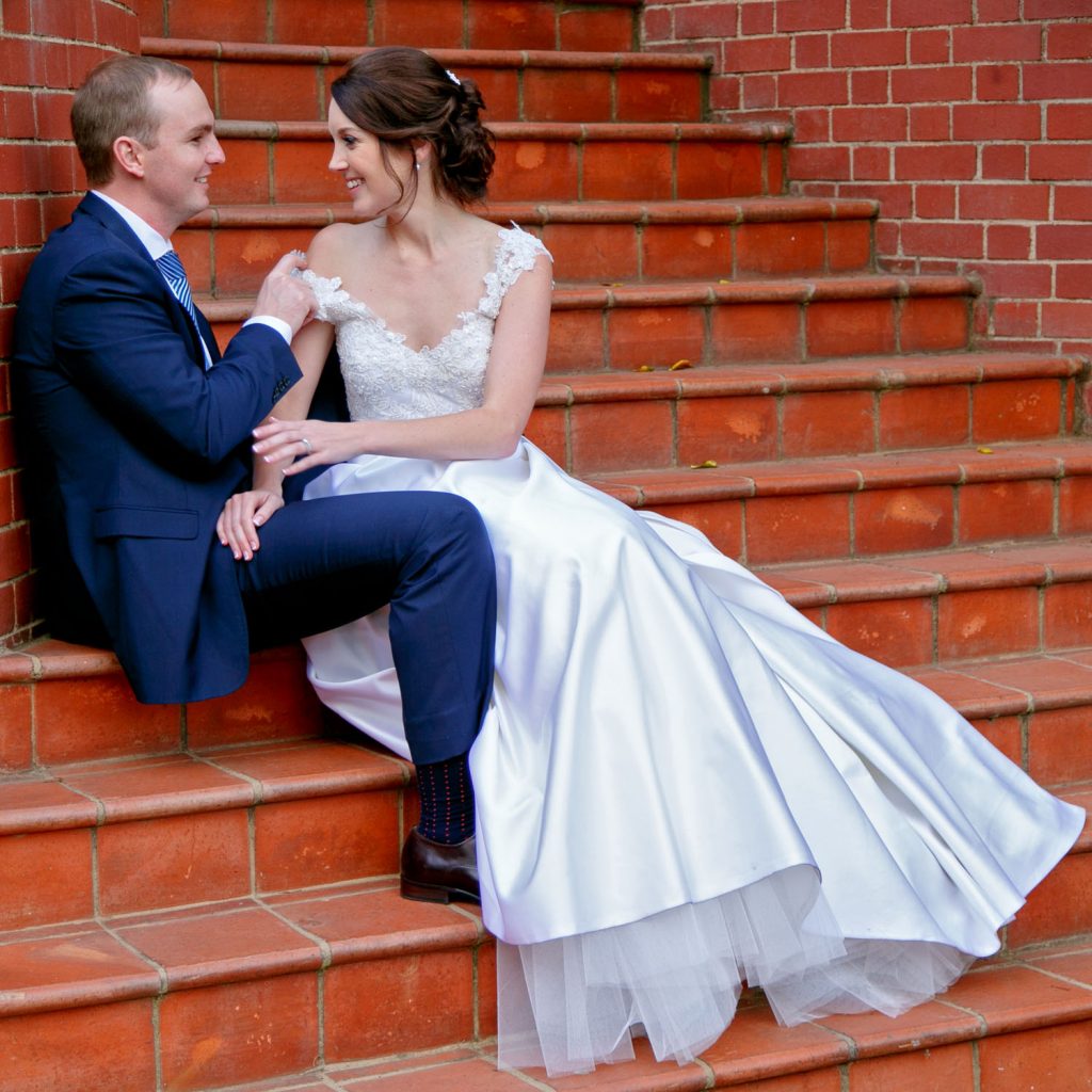 Emoyeni Estate Weddings couple sitting on red stairs