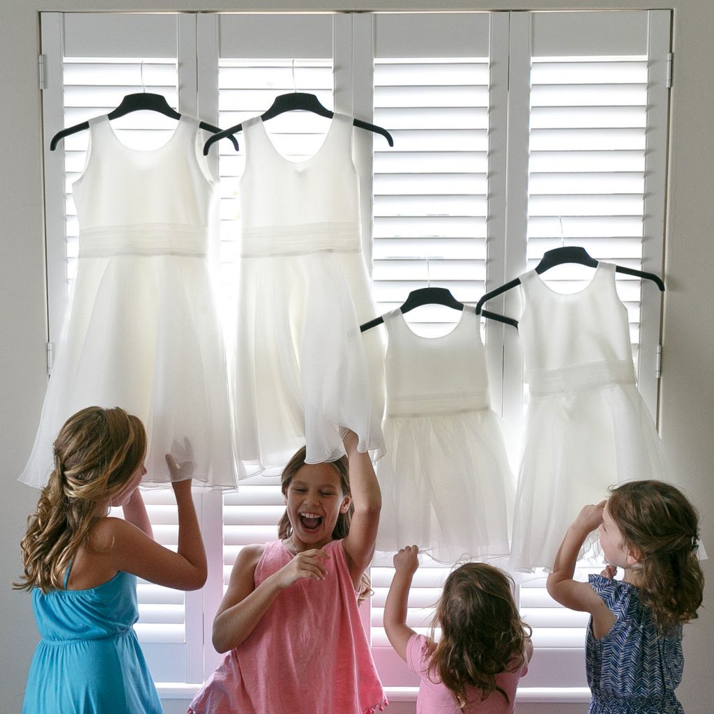 Little girls admiring their wedding dresses
