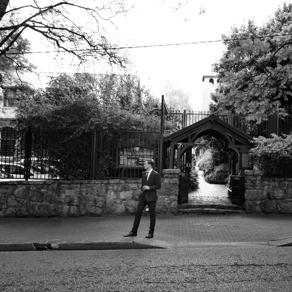 The Brides brother waiting for the wedding car at St George's Anglican Church in Parktown Johannesburg