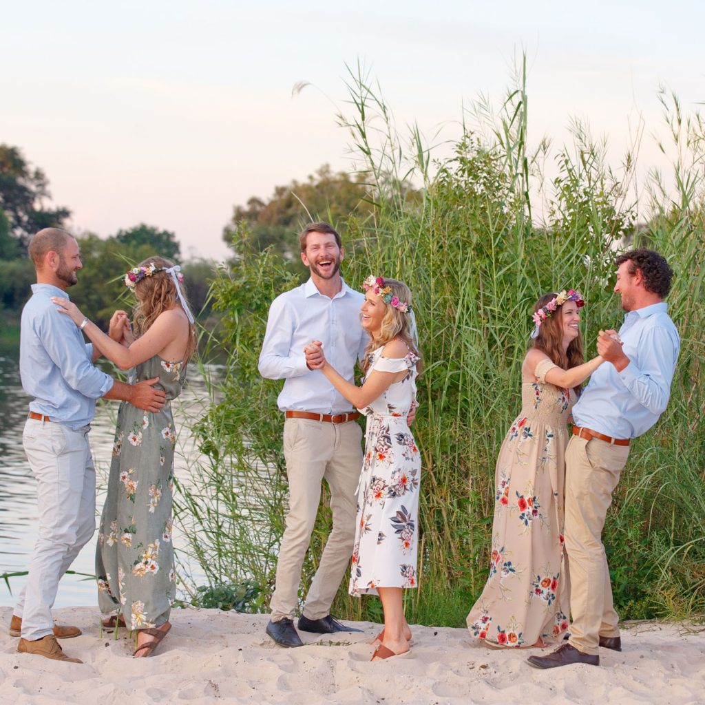 wedding guests dancing on the banks of the Zambezi River Victoria Falls Zimbabwe