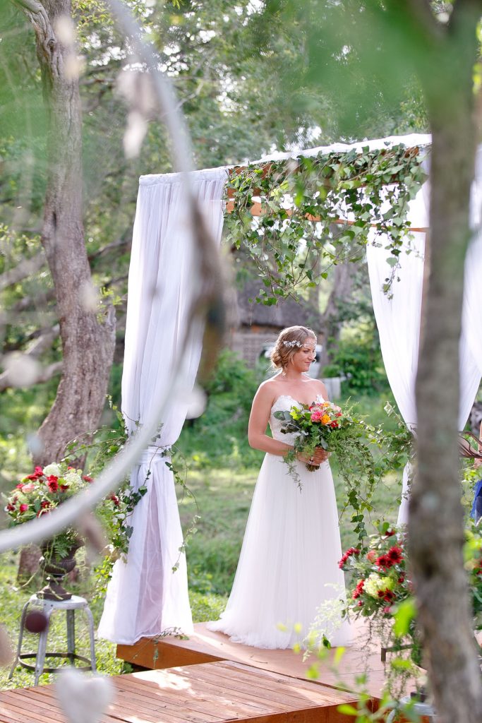 bride standing on the banks of the Zambezi River in Zimbabwe