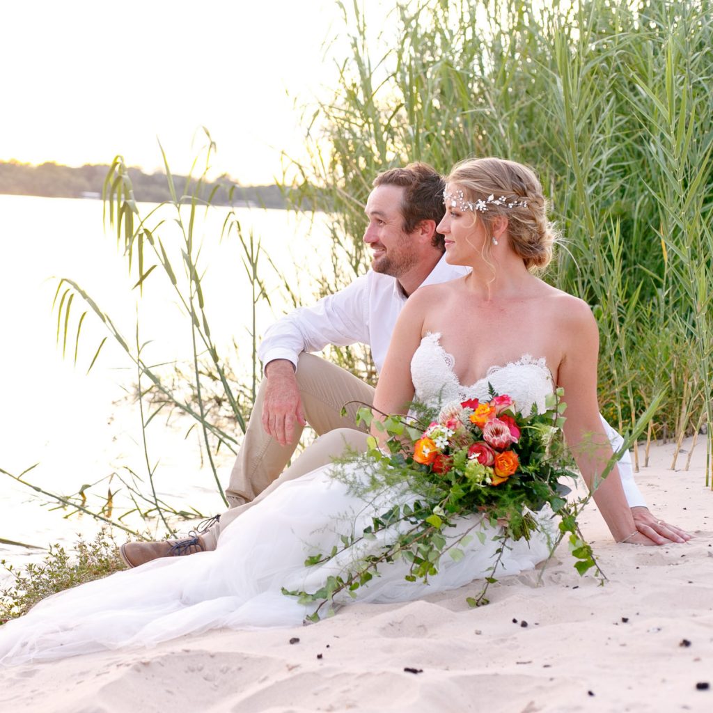 wedding couple sitting on the banks of the at Zambezi River in Zimbabwe