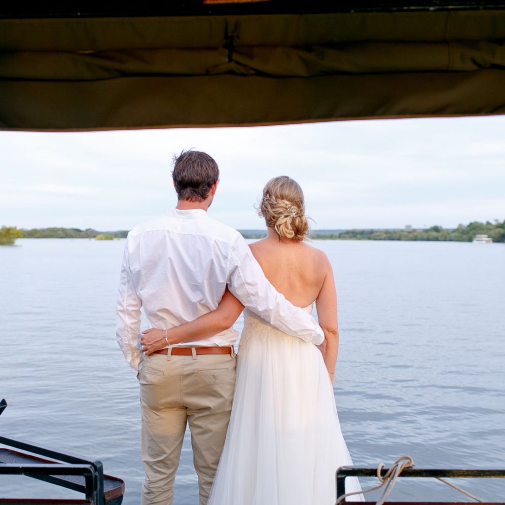 wedding couple standing on a boat at Zambezi House Victoria Falls Zimbabwe