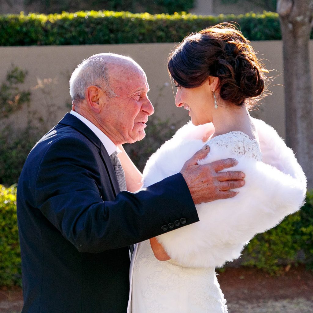 Dad hugging bride at the Hellenic Hall in Bedfordview Johannesburg