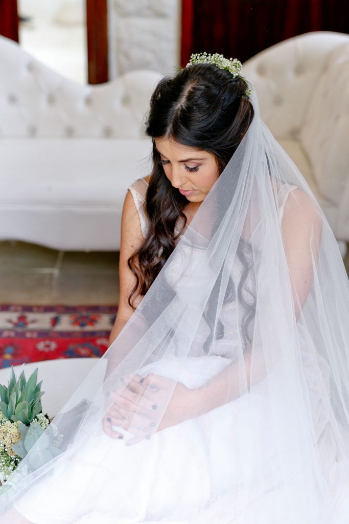 Jewish bride in a white dress posing at Shepstone Gardens