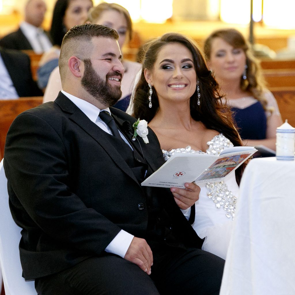 Bride smiling inside the church at Our Lady of Cedars in Woodmead
