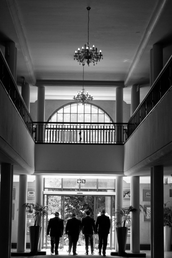 Wedding portrait of the men in black suits at The Wanderers Hotel in Johannesburg