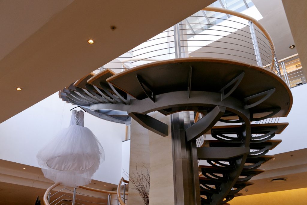 White wedding dress hanging on stairs at The Wanderers Hotel in Johannesburg