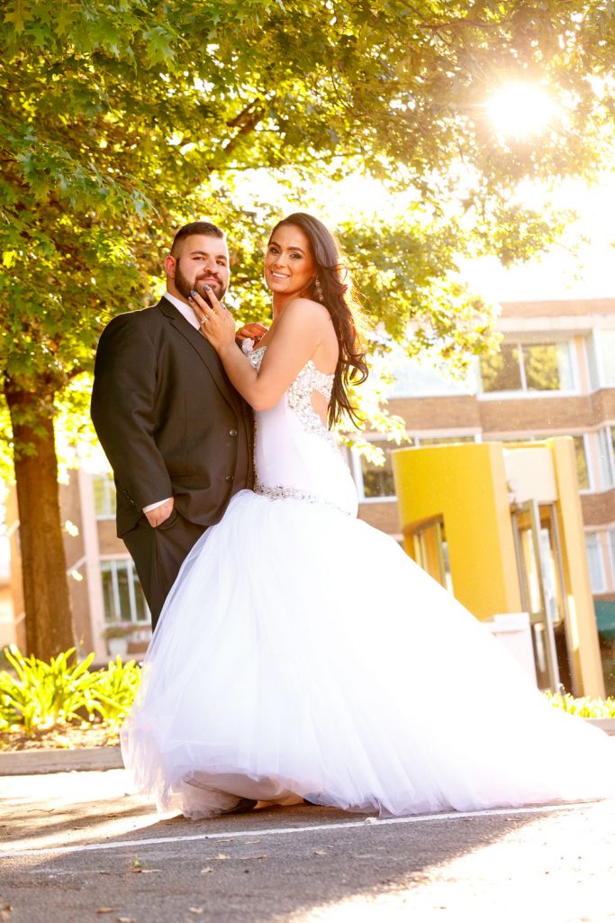 Happy wedding couple standing under the tree at The Wanderers Club