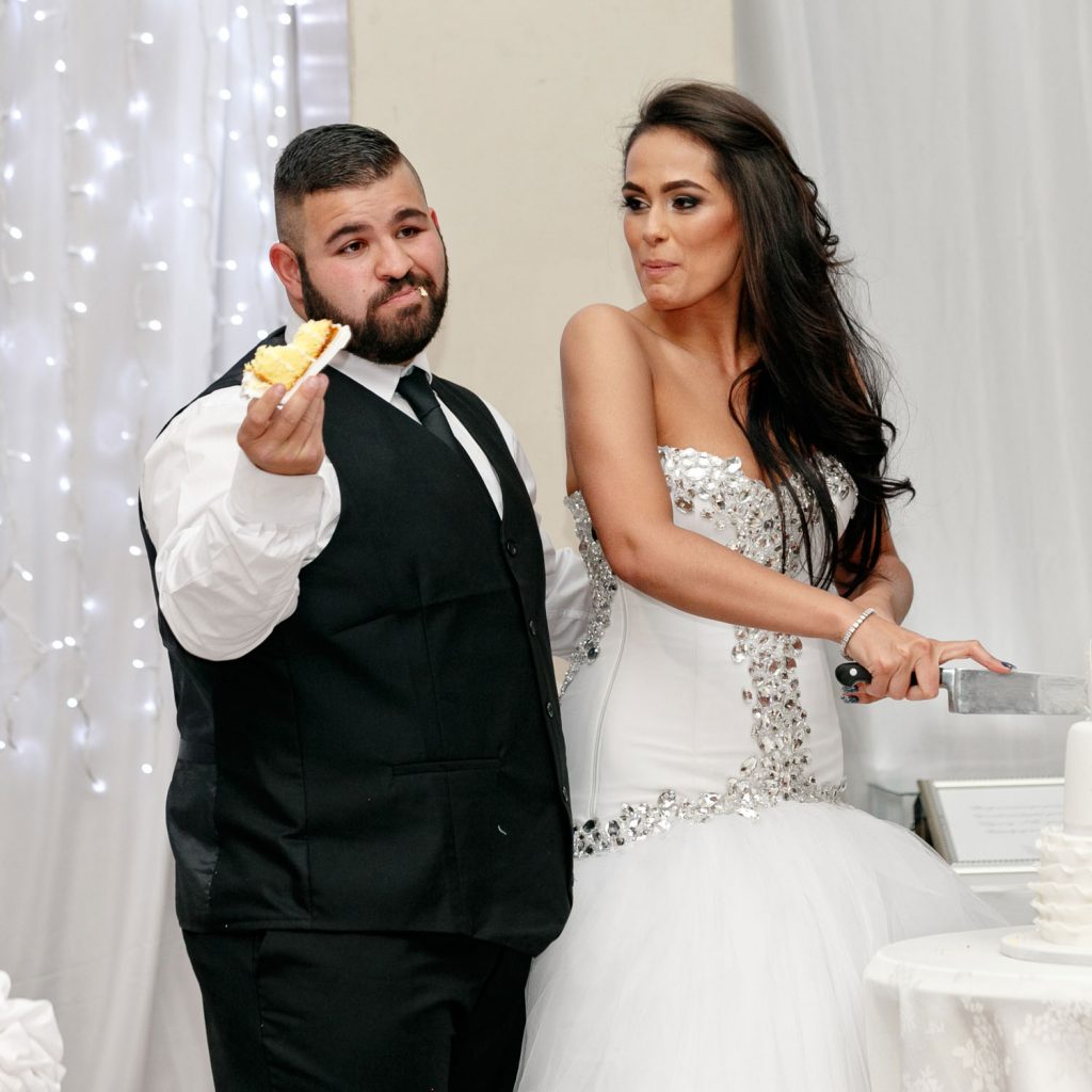 Groom eating his wedding cake at Wanderers Club in Illovo